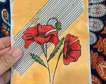 Red poppy on handmade paper