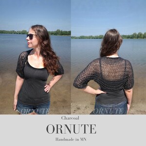 May include: Charcoal-colored, open-weave shrug with short sleeves. The garment is shown on a person, with the front and back views displayed. The word "ORNUTE" is printed in a serif font below the image, with "Handmade in MN" below it.