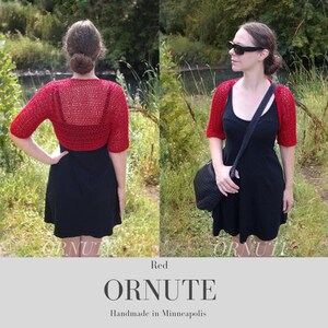 May include: A red, short-sleeved, crocheted bolero. The bolero is worn over a black dress. The image also includes the text "Red ORNUTE Handmade in Minneapolis".