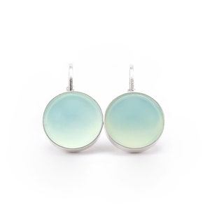 May include: A pair of silver earrings with light blue and green oval-shaped stones.