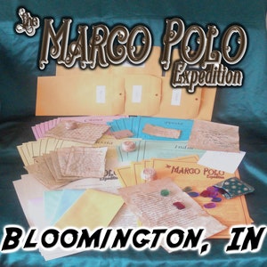 May include: The Marco Polo Expedition game set with various colored papers, envelopes, and small decorative items. The text "The Marco Polo Expedition" is displayed in a stylized font, with "Bloomington, IN" at the bottom.