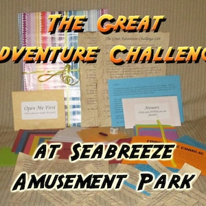 May include: A collection of colorful paper items, including cards and envelopes, with the text "THE GREAT ADVENTURE CHALLENGE AT SEABREEZE AMUSEMENT PARK." Some items are tied with a green ribbon. One card reads "Open Me First."