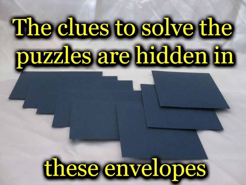 May include: A collection of navy blue envelopes arranged on a white surface. The text at the top reads "The clues to solve the puzzles are hidden in" and the text at the bottom reads "these envelopes".