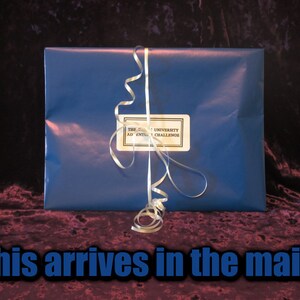 May include: A wrapped gift in blue paper with a white ribbon. A label on the front reads "The [University] Adventure Challenge." The text "This arrives in the mail..." is at the bottom of the image.