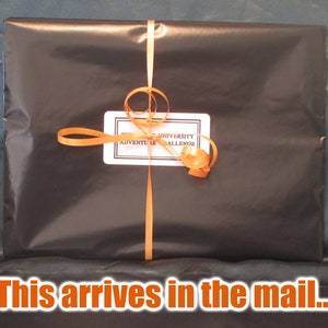 May include: A wrapped package in black paper, tied with an orange ribbon and bow. A white label with black text reads "Adventure Challenge". The text "This arrives in the mail..." is at the bottom of the image.