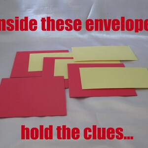 May include: Arrangement of red and yellow rectangular cards. The text "Inside these envelopes hold the clues..." is displayed in red, indicating a game or puzzle theme. The cards are arranged on a white surface.
