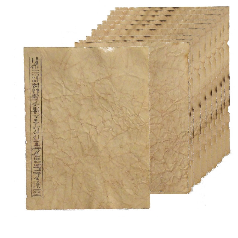 May include: A stack of aged parchment paper sheets. The paper has a textured, wrinkled appearance with a light brown color. A vertical column of hieroglyphs is printed on the left side of the front sheet. The edges of the paper have a slightly darker, burnt look.