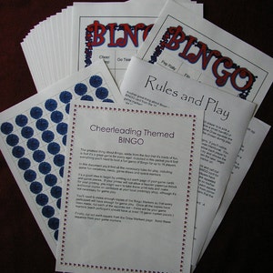 May include: A collection of printed Bingo game materials, including sheets with the word "BINGO" in red and blue, rules, and marker sheets with blue circles. The theme is "Cheerleading".