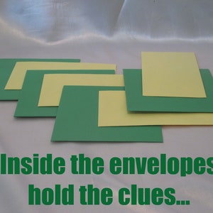 May include: Green and yellow paper squares and rectangles are arranged in a layered pattern. The text "Inside the envelopes hold the clues..." is printed in green at the bottom of the image.