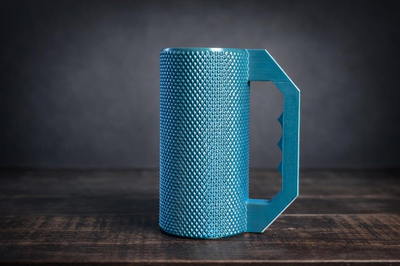 Peut inclure: Un mug cylindrique bleu sarcelle dot&eacute; d'une surface textur&eacute;e &agrave; motif de losanges et d'une poign&eacute;e g&eacute;om&eacute;trique avec trois empreintes digitales distinctes. Le mug pr&eacute;sente une finition mate et un design droit et vertical pour une prise en main.