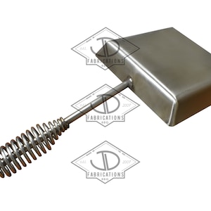 May include: A stainless steel BBQ press with a rectangular cooking surface and a spring handle. The handle is designed for a comfortable grip. The product has the text "JD Fabrications BBQ" on it.