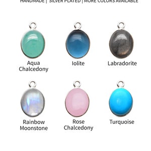 May include: Six oval-shaped pendants with silver plated settings. The pendants are in the following colors: aqua, blue, gray, iridescent, pink, and turquoise. The pendants are 10mm by 12mm.