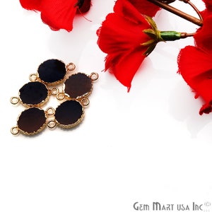 May include: Six gold-toned metal connector charms with black and brown oval glass inserts. Each charm has two loops for attaching to jewelry.