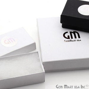 May include: Three white gift boxes with a black gift box. The white boxes have the logo "GM GemMart USA" printed on them. The black box has a white circle on the top.