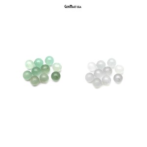 May include: Two groups of round, smooth, polished jade beads. One group is green and the other is white.