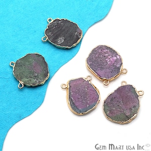 May include: Four irregularly shaped gemstone pendants with gold-toned jump rings. The gemstones are a mix of purple, green, and black.