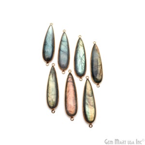 May include: Seven teardrop-shaped labradorite pendants with gold-colored metal trim. The pendants vary in color, with shades of blue, gray, and pink. Each pendant has a small loop at the top and bottom for attaching to jewelry.