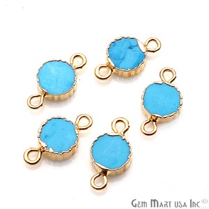May include: Five turquoise blue gemstone connector charms with gold-toned metal settings and two loops. The charms are round and have a slightly irregular shape.