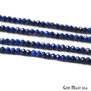 May include: A strand of deep blue lapis lazuli beads, faceted and round, strung together for jewelry making.