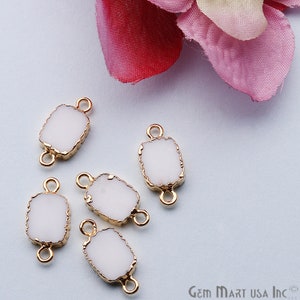 May include: Five white rectangular connector charms with gold-toned edges and two loops on each side. The charms are scattered on a light blue surface.