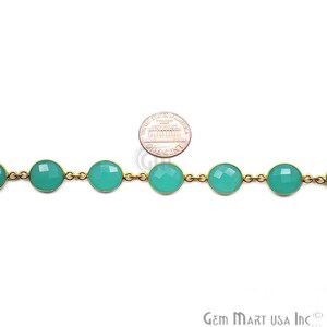 May include: A gold chain with round, teal-colored gemstone beads. The chain is shown next to a US penny for size comparison. Gem Mart USA Inc. is printed on the bottom right corner of the image.