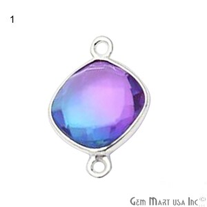 May include: A silver-toned pendant with a square-shaped, iridescent blue and purple gemstone. The pendant has two loops on the top and bottom for attaching to a chain or cord.