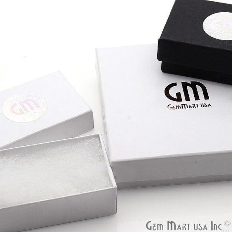 May include: Three white gift boxes with a white foam insert. The largest box has the logo "GM GemMart USA" printed on the top.