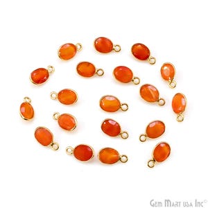 May include: Orange oval-shaped gemstone charms with gold-colored metal settings and loops. The gemstones have a polished, translucent appearance. These charms are suitable for jewelry making and crafting projects.