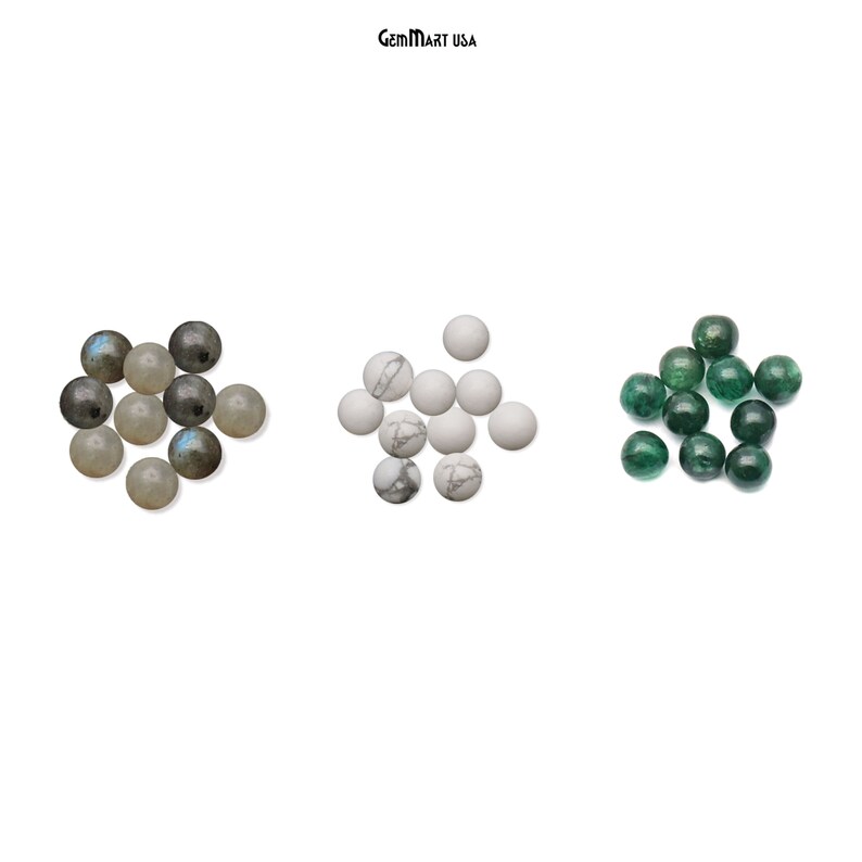 May include: A collection of round gemstone beads in three colours: grey, white, and green. The beads are arranged in three groups, with the grey beads on the left, the white beads in the centre, and the green beads on the right.