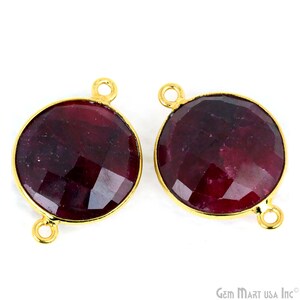 May include: Two round, gold-toned, gemstone connector charms with a faceted, dark red ruby stone. Each charm has two jump rings for attaching to jewelry.