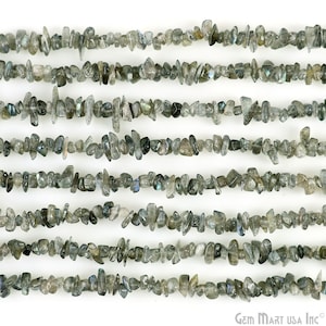 May include: A strand of gray and black labradorite chip beads. The beads are irregular in shape and size, with a slightly iridescent sheen.