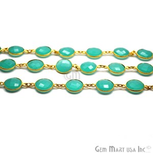 May include: A turquoise gemstone chain with gold links. The chain is made of round, faceted gemstones and gold chain links.