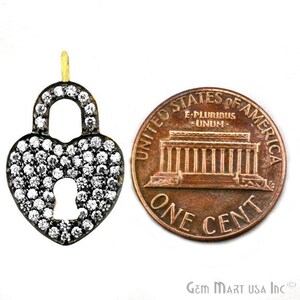 May include: A silver heart-shaped padlock charm with a clear crystal design. The charm is about the size of a US penny.