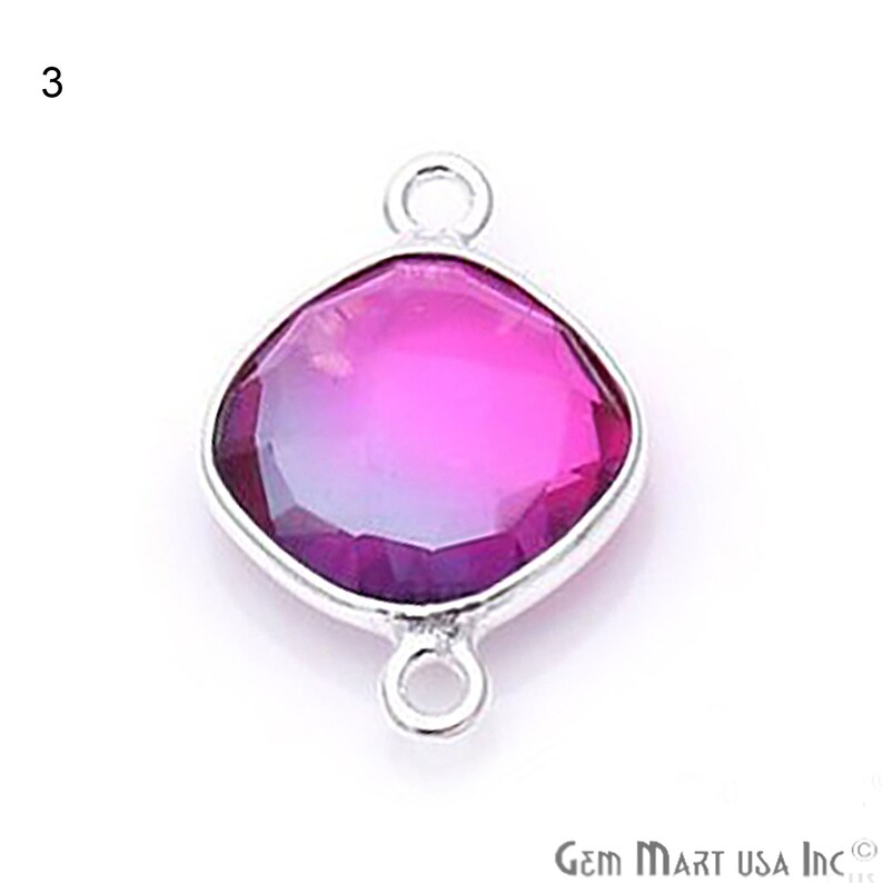 May include: A silver-toned pendant with a faceted, pink and purple gemstone. The pendant has two loops for attaching to a chain or cord.