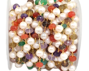 May include: A white pearl and gemstone chain with gold accents. The chain features a variety of gemstones, including amethyst, carnelian, emerald, and smoky quartz.