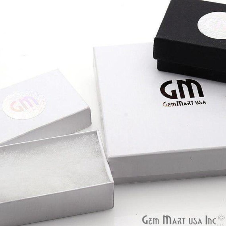 May include: Three white gift boxes with a white foam insert. The largest box has the logo "GM GemMart USA" printed on the top.