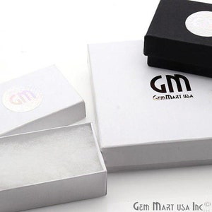 May include: Three white gift boxes with a black box in the background. The white boxes have a logo that says "GemMart USA".