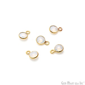 May include: Five gold-toned charms with white opal stones. Each charm has a small loop for attaching to jewelry.