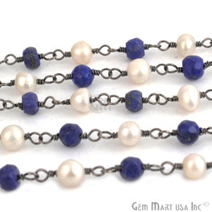 May include: A strand of beads made with white pearls and dark blue lapis lazuli stones. The beads are strung on a silver chain.