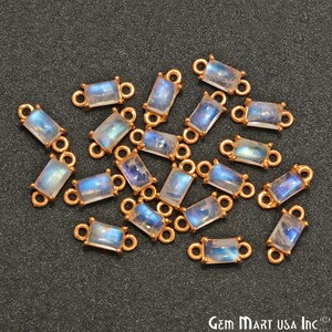 May include: A group of 20 gold-toned gemstone connectors with a rectangular moonstone gemstone. The connectors have two loops on each side for attaching to jewellery.