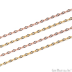 May include: Four strands of gold and rose gold chain, each with a delicate, oval-shaped link. The chains are arranged in a diagonal pattern against a white background.