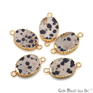 May include: Five gold-toned oval-shaped gemstone connector charms with a black and white dalmatian jasper pattern. Each charm has two gold-toned jump rings.