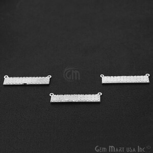 May include: Three silver-toned rectangular bar pendants with clear crystal embellishments. The pendants have two jump rings on each side for attaching to a chain or cord.