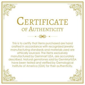 May include: A certificate of authenticity with a gold border and ornate design. The text reads "CERTIFICATE OF AUTHENTICITY". The text below states that items purchased are hand-crafted in accordance with recognized jewelry manufacturing standards and materials used are ethically sourced. The items exclusively manufactured by Gemmart USA, are accurately described. Natural gemstones sold by GemMartUSA have been tested and verified by Gemological Institute of America (GIA) for their authenticity.
