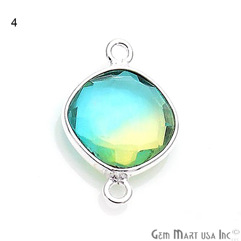 May include: A silver-toned pendant with a square-shaped, faceted, iridescent gemstone. The gemstone is a gradient of blue, green, and yellow. The pendant has two loops for attaching a chain.