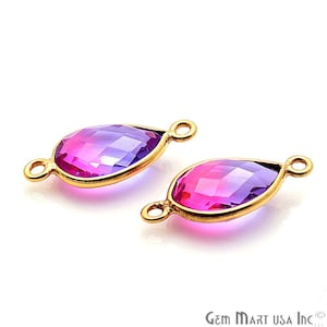 May include: Two gold-toned teardrop-shaped connectors with faceted purple and pink glass stones. The connectors have two loops on each side for attaching jewelry.