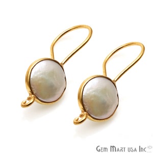May include: A pair of gold earrings with white pearl accents. The earrings have a simple, elegant design and are perfect for everyday wear.