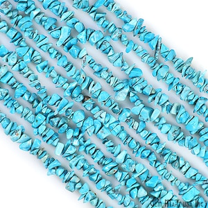May include: A strand of turquoise chip beads. The beads are a bright blue color and are irregular in shape. They are strung on a clear thread.