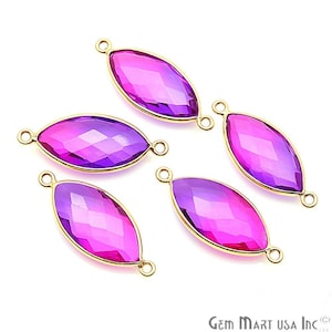 May include: Four purple and pink glass marquise shaped connector charms with gold-tone jump rings. The charms are faceted and have a gradient color.