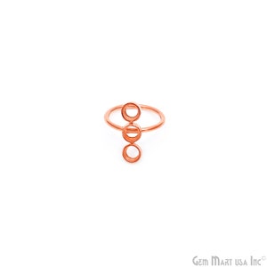May include: A rose gold ring with three round cutouts. The ring is designed to hold gemstones.
